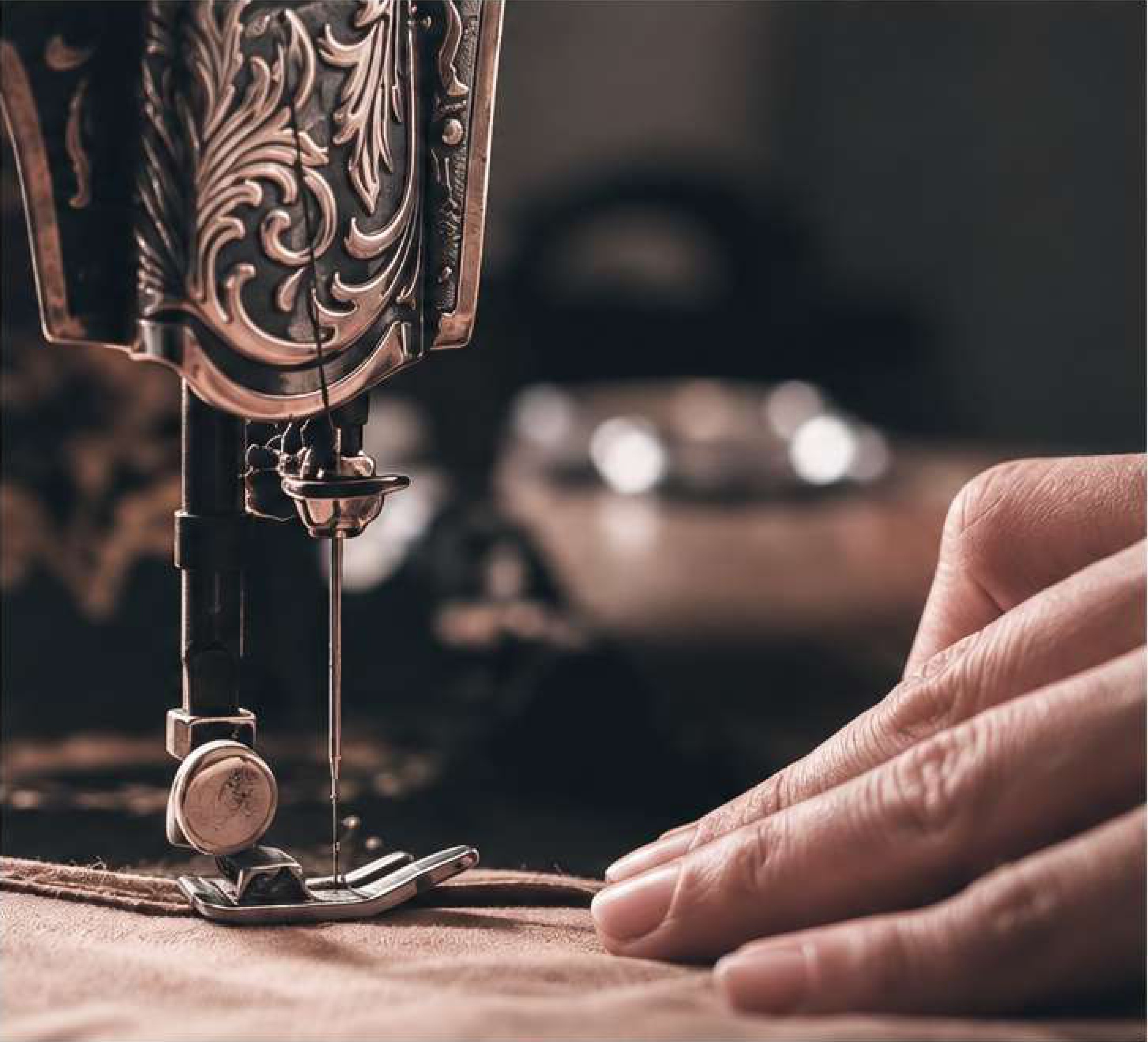 Detailed sewing-machine needle and hands stitching fabric from the company profile